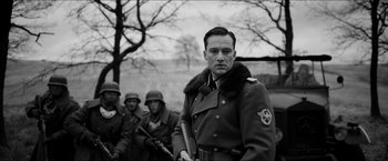 Movie still from “The Captain” (2017), directed by Robert Schwentke – Black and white photograph of a man in a military uniform; Medium shot, Low angle