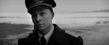 Movie still from “The Captain” (2017), directed by Robert Schwentke – Black and white photograph of a man in a military uniform; Close Up shot, Low angle