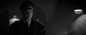 Movie still from “The Captain” (2017), directed by Robert Schwentke – A black and white photo of a man in a military uniform; Close Up shot, Low angle