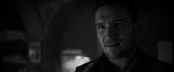 Movie still from “The Captain” (2017), directed by Robert Schwentke – Black and white photograph of a man in a dark room; Close Up shot, Over the shoulder angle
