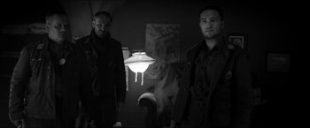 Movie still from “The Captain” (2017), directed by Robert Schwentke – A couple of men standing next to each other in a room; Medium shot, Low angle