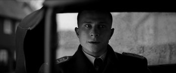Movie still from “The Captain” (2017), directed by Robert Schwentke – A black and white photo of a man in a uniform; Close Up shot, Low angle