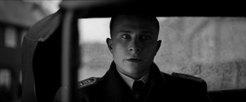 Movie still from “The Captain” (2017), directed by Robert Schwentke – Black and white photograph of a man in military uniform; Close Up shot, Low angle