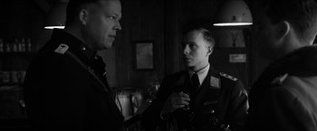 Movie still from “The Captain” (2017), directed by Robert Schwentke – Two men in military uniforms talking to each other; Close Up shot, Over the shoulder angle