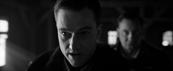 Movie still from “The Captain” (2017), directed by Robert Schwentke – Black and white photograph of a man in a suit; Close Up shot, Low angle
