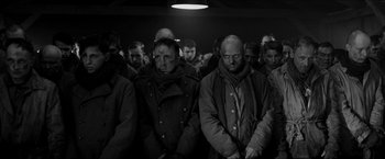 Movie still from “The Captain” (2017), directed by Robert Schwentke – Black and white photograph of a group of men in coats and scarves; Medium shot, High angle