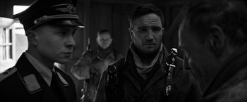 Movie still from “The Captain” (2017), directed by Robert Schwentke – A black - and - white photo of a man with a camera; Close Up shot, Over the shoulder angle