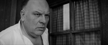 Movie still from “The Captain” (2017), directed by Robert Schwentke – Black and white photograph of a bald man looking at the camera; Close Up shot, Low angle