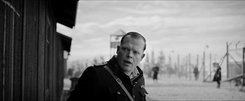Movie still from “The Captain” (2017), directed by Robert Schwentke – Black and white photograph of a man in a military uniform; Medium shot, Over the shoulder angle