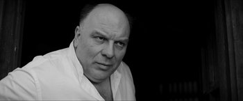 Movie still from “The Captain” (2017), directed by Robert Schwentke – Black and white photograph of a man with a bald head; Close Up shot, Low angle