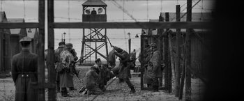 Movie still from “The Captain” (2017), directed by Robert Schwentke – A black and white photo of men in military gear; Wide shot, Low angle