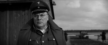 Movie still from “The Captain” (2017), directed by Robert Schwentke – A man in a military uniform and a hat; Close Up shot, Low angle