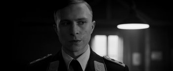 Movie still from “The Captain” (2017), directed by Robert Schwentke – Black and white photograph of a man in military uniform; Close Up shot, Low angle