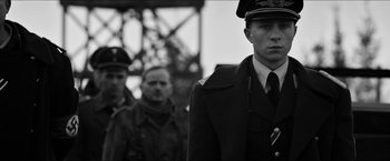 Movie still from “The Captain” (2017), directed by Robert Schwentke – A black and white photo of a man in a military uniform; Medium shot, Low angle