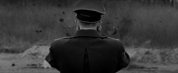 Movie still from “The Captain” (2017), directed by Robert Schwentke – A black and white photo of a man in a military uniform; Close Up shot, Low angle