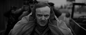 Movie still from “The Captain” (2017), directed by Robert Schwentke – An old man with his hands on his head; Close Up shot, Over the shoulder angle