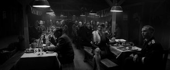 Movie still from “The Captain” (2017), directed by Robert Schwentke – A group of people sitting around a table; Wide shot, High angle