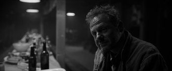 Movie still from “The Captain” (2017), directed by Robert Schwentke – Black and white photograph of a man in a dark room; Close Up shot, Over the shoulder angle