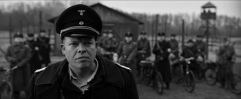 Movie still from “The Captain” (2017), directed by Robert Schwentke – Black and white photograph of a man in a military uniform; Close Up shot, Over the shoulder angle