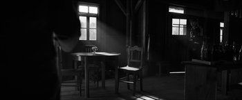 Movie still from “The Captain” (2017), directed by Robert Schwentke – A table and chair in a room with a window; Wide shot, High angle