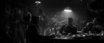 Movie still from “The Captain” (2017), directed by Robert Schwentke – A group of men sitting at a table in a room; Wide shot, High angle