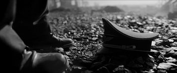 Movie still from “The Captain” (2017), directed by Robert Schwentke – A pair of shoes and a hat on the ground; Close Up shot, Low angle