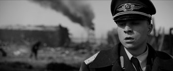 Movie still from “The Captain” (2017), directed by Robert Schwentke – A black and white photo of a man in a military uniform; Close Up shot, Low angle