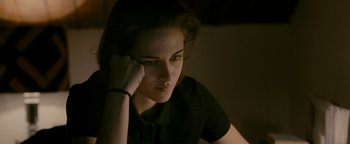 Movie still from “Personal Shopper” (2016), directed by Olivier Assayas – A young woman sitting in front of a window; Close Up shot, High angle
