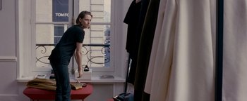 Movie still from “Personal Shopper” (2016), directed by Olivier Assayas – A woman standing in front of a mirror looking in the mirror; Wide shot, Over the shoulder angle