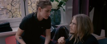 Movie still from “Personal Shopper” (2016), directed by Olivier Assayas – Two people sitting on the ground talking to each other; Medium shot, Over the shoulder angle