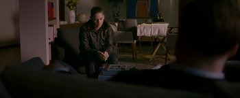 Movie still from “Personal Shopper” (2016), directed by Olivier Assayas – A woman sitting on a couch in a living room; Wide shot, Over the shoulder angle