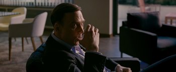 Movie still from “Personal Shopper” (2016), directed by Olivier Assayas – A person sitting down with a drink in his hand; Close Up shot, Over the shoulder angle