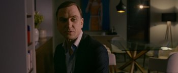 Movie still from “Personal Shopper” (2016), directed by Olivier Assayas – A person wearing a suit and tie; Medium shot, Over the shoulder angle