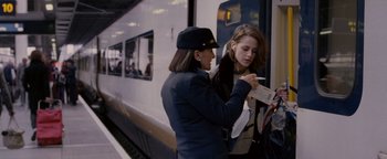 Movie still from “Personal Shopper” (2016), directed by Olivier Assayas – Two women standing next to each other on a train platform; Medium shot, Over the shoulder angle