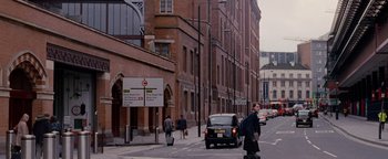Movie still from “Personal Shopper” (2016), directed by Olivier Assayas – A man walking down a street next to a building; Extreme Wide shot, Over the shoulder angle