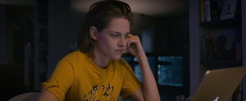 Movie still from “Personal Shopper” (2016), directed by Olivier Assayas – A woman sitting down with her hand on her face; Close Up shot, Over the shoulder angle