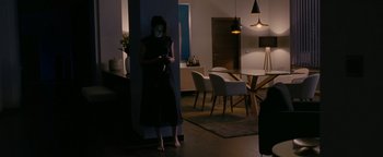 Movie still from “Personal Shopper” (2016), directed by Olivier Assayas – A woman standing in a living room looking at her cell phone; Wide shot, High angle