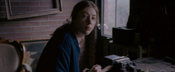 Movie still from “Personal Shopper” (2016), directed by Olivier Assayas – A young woman sitting in front of a window; Close Up shot, Over the shoulder angle