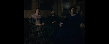 Movie still from “Personal Shopper” (2016), directed by Olivier Assayas – A group of people sitting in a room; Medium shot, Low angle