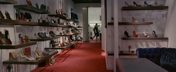 Movie still from “Personal Shopper” (2016), directed by Olivier Assayas – A woman walking down the aisle of a shoe store; Wide shot, High angle