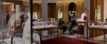 Movie still from “Personal Shopper” (2016), directed by Olivier Assayas – Two people sitting at a table in a jewelry store; Wide shot, Over the shoulder angle