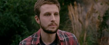 Movie still from “Personal Shopper” (2016), directed by Olivier Assayas – A person wearing a plaid shirt; Close Up shot, Over the shoulder angle