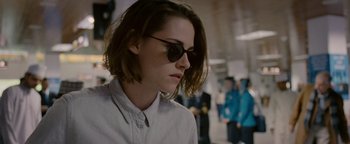 Movie still from “Personal Shopper” (2016), directed by Olivier Assayas – A person wearing sunglasses; Close Up shot, Over the shoulder angle