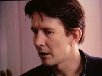 Movie still from “The Celebration” (1998), directed by Thomas Vinterberg – A person wearing a black shirt; Close Up shot, Over the shoulder angle