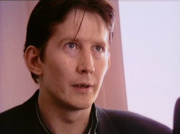 Movie still from “The Celebration” (1998), directed by Thomas Vinterberg – A person looking at the camera; Close Up shot, Low angle