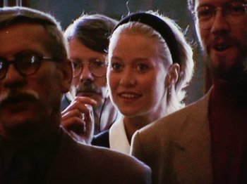 Movie still from “The Celebration” (1998), directed by Thomas Vinterberg – A group of people standing next to each other in a room; Close Up shot, Over the shoulder angle