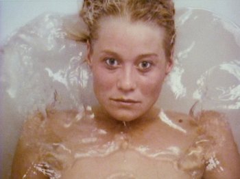Movie still from “The Celebration” (1998), directed by Thomas Vinterberg – A young woman in a bath tub covered in water; Extreme Close Up shot, Overhead angle