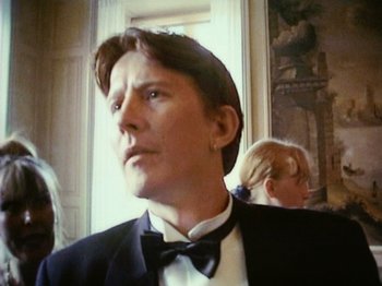 Movie still from “The Celebration” (1998), directed by Thomas Vinterberg – A man wearing a tuxedo and a bow tie; Close Up shot, Low angle