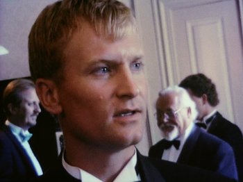 Movie still from “The Celebration” (1998), directed by Thomas Vinterberg – A person wearing a suit and tie; Close Up shot, Low angle
