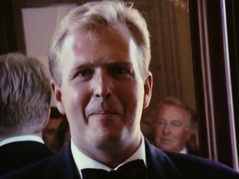 Movie still from “The Celebration” (1998), directed by Thomas Vinterberg – A person wearing a suit and bow tie; Close Up shot, Low angle